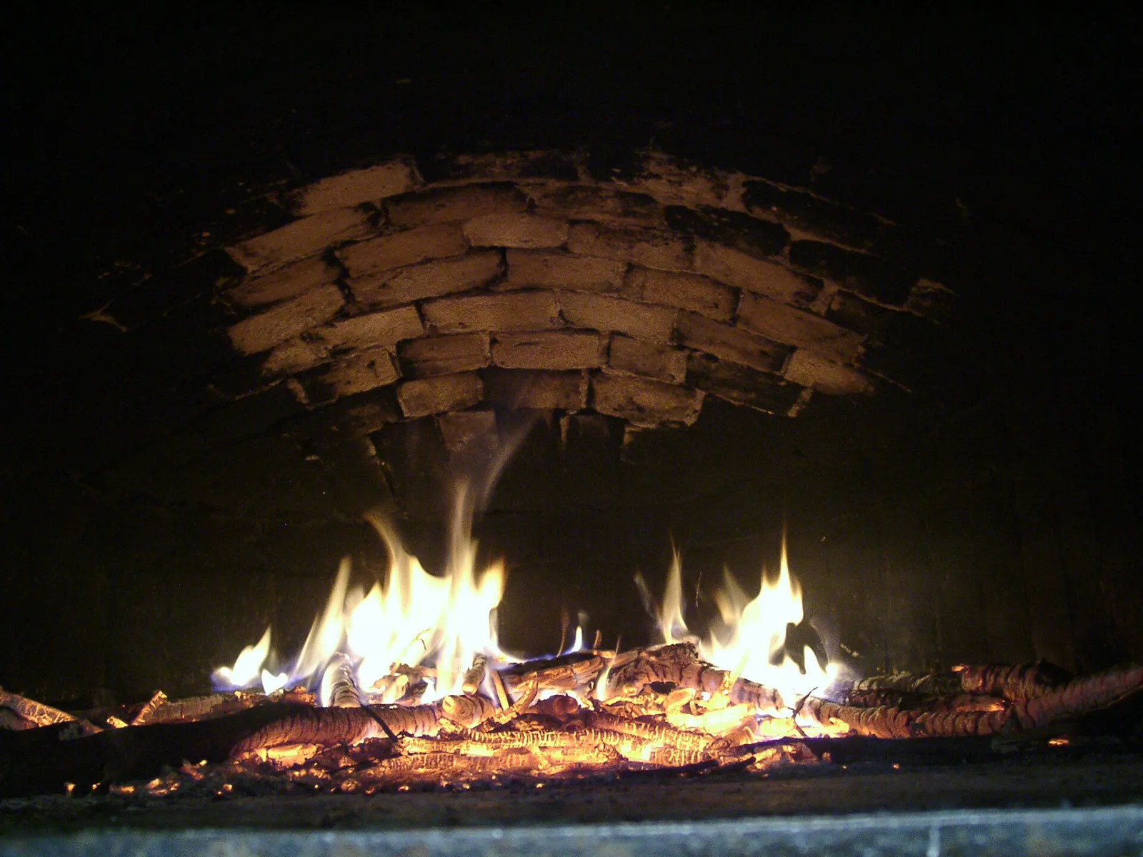 L'intérieur d'un four à pain chauffé au bois, dont les briques commencent à blanchir